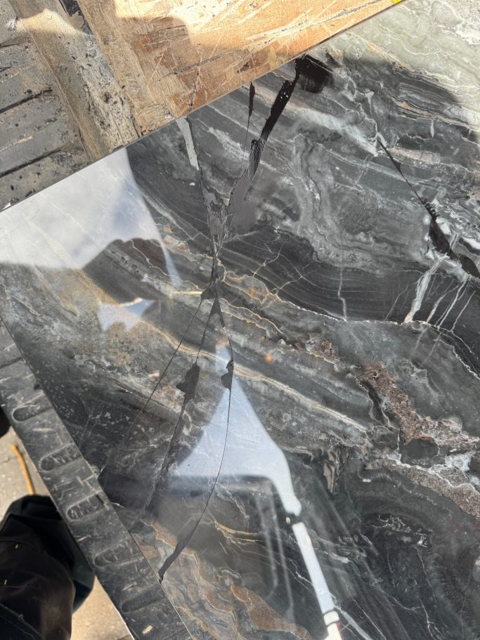Before repair: shattered stone coffee table Shattered stone coffee tabletop before restoration.