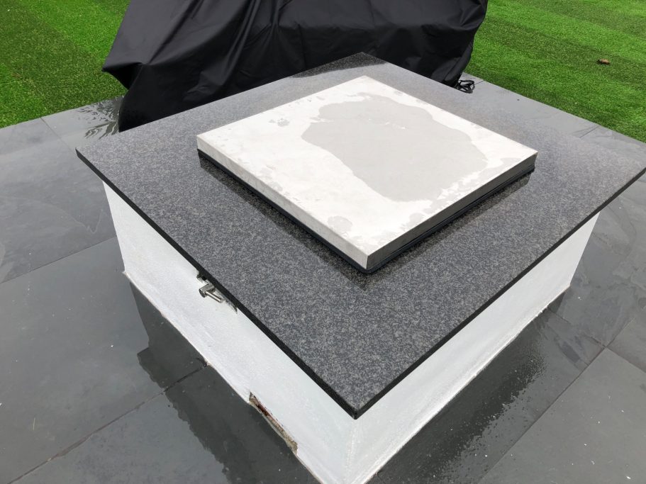 Completed fire pit with granite top Completed outdoor fire pit with a granite top.
