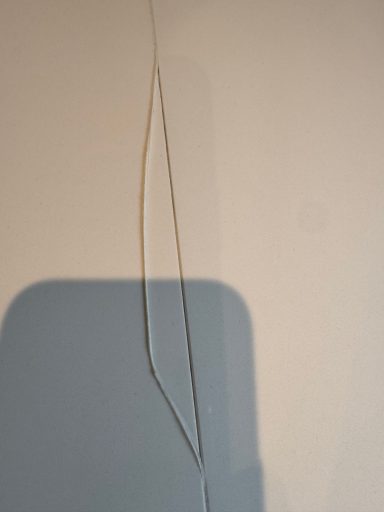 Corian white kitchen worktop in garforth leeds showing the joint silicone sealer coming out of the joint. This is just wear and tear.