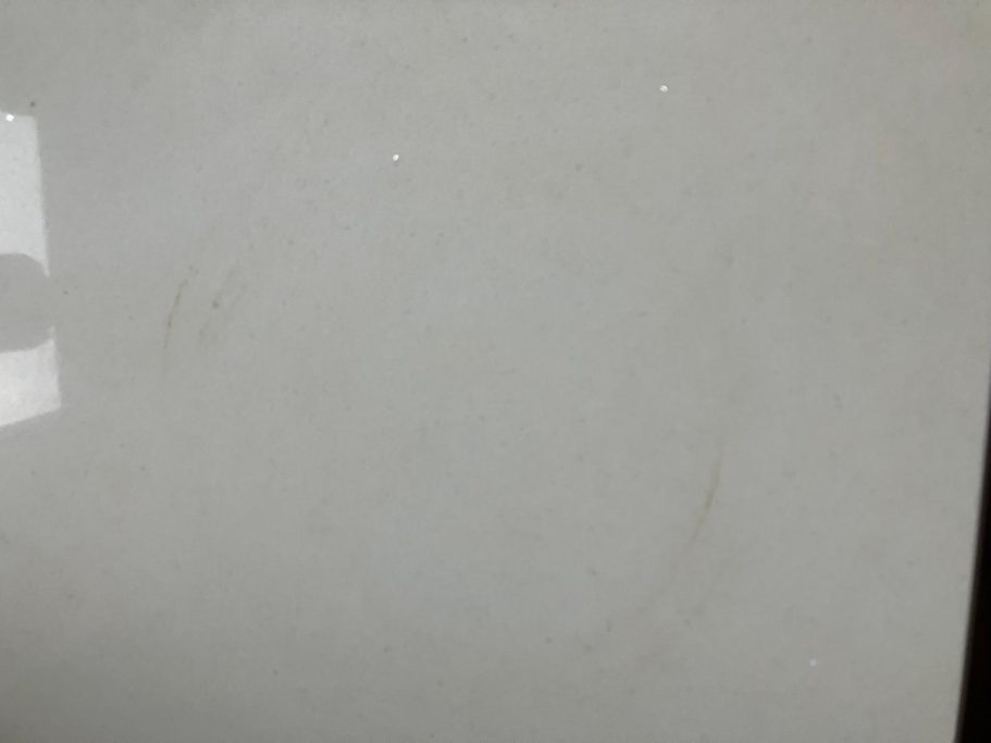 After repair: treated heat mark on quartz Quartz worktop repair showing a burn mark which had to be sanded to get the cicle shape out. It was very deep.