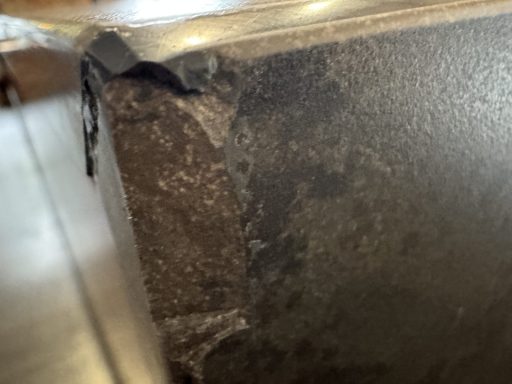 Before: corner damage close-up Close-up of damaged Dekton corner before repair at the Dodworth property.