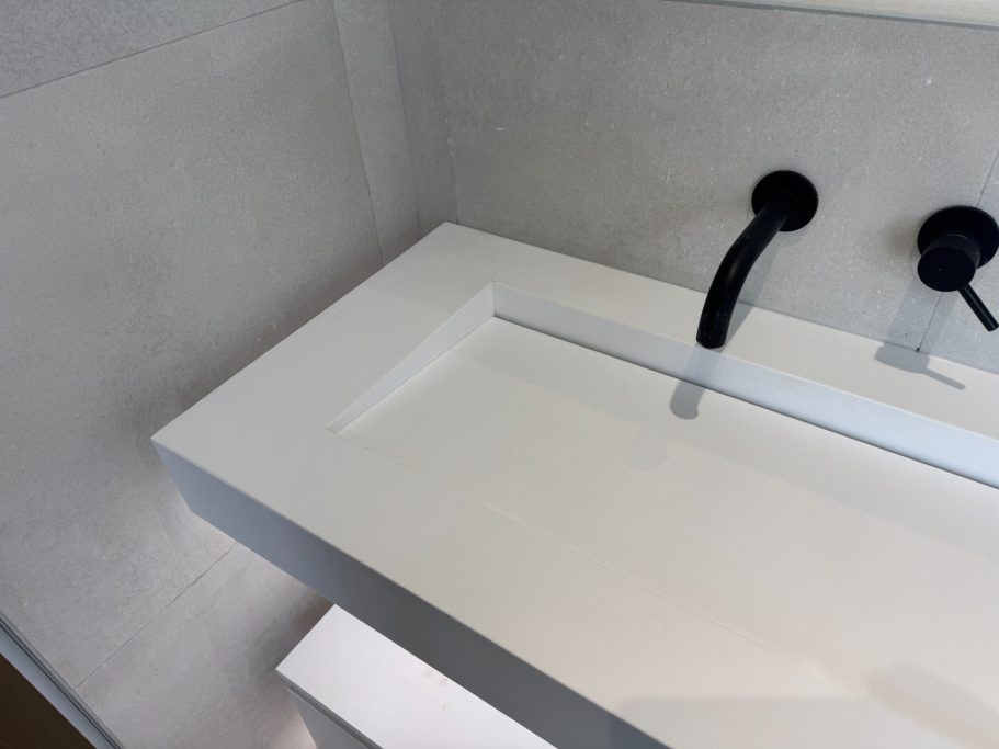 After repair: restored Corian vanity top Finished vanity corian top in bathroom. Picture showing the finished repair at the corner which was cracked from corner to corner.