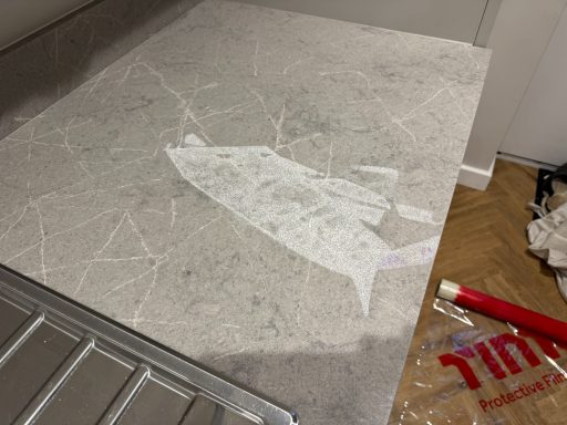 Quartz worktop damaged with oven cleaner. Surface burnt with the acid from the oven cleaner product.
