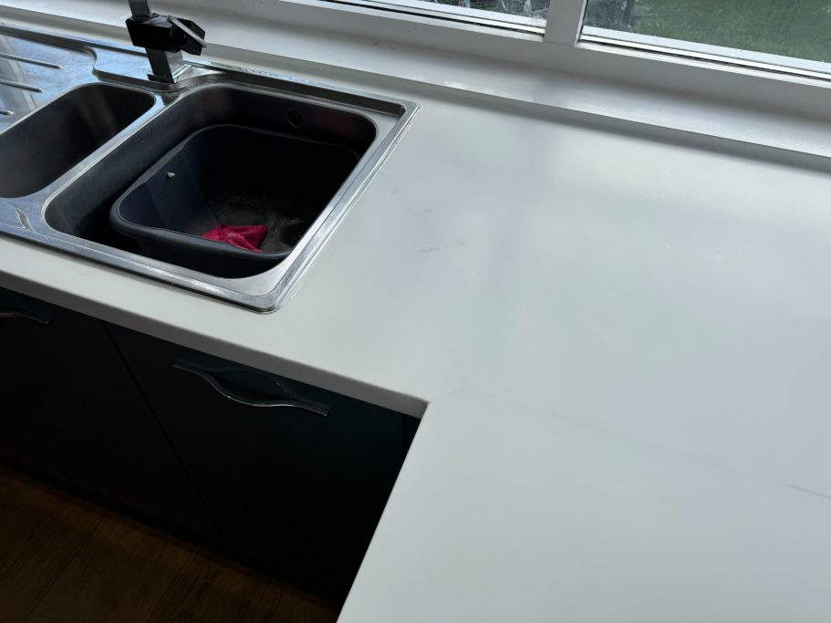 After repair: restored Corian joint in Roundhay Finished corian worktop repair at the joint. Water damage caused the corian split because ot water swelling the wood underneath.
