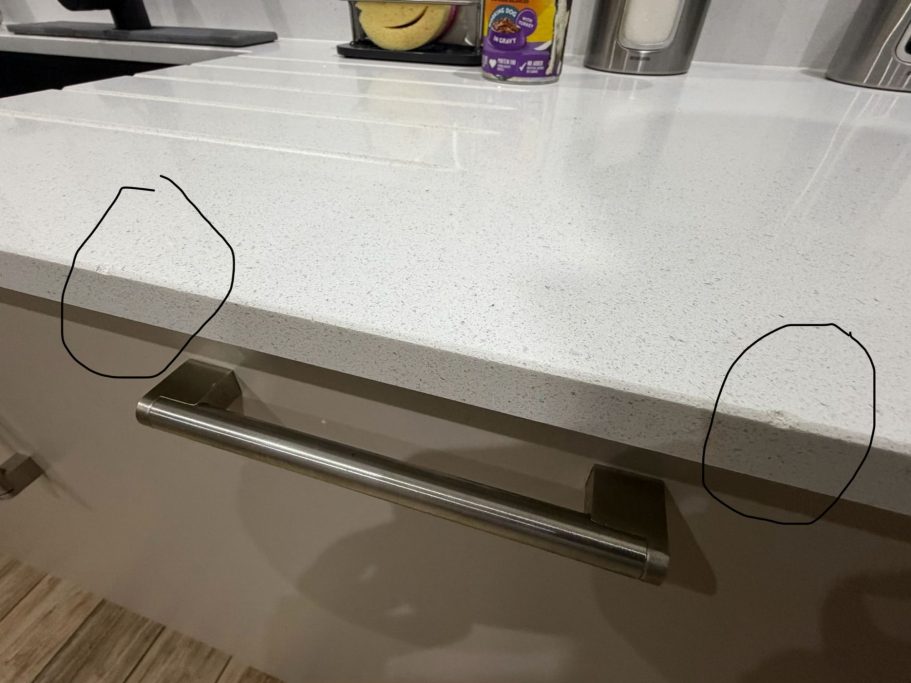 Before repair: chipped quartz in East Ardsley Quartz Worktop repair in East Ardsley, Wakefield area. Damaged quartz worktop was chipped on the polished edge with 2no chunks missing.