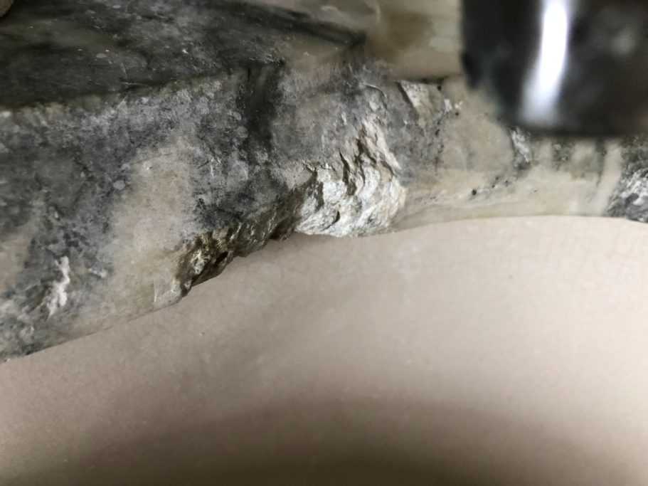 Before repair: damaged antique marble vanity edge Antique marble vanity top in a stately home in harrogate leeds west yorkshire.