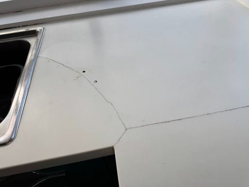 White corian repair in leeds. Joint had cracked and the worktop was also split  at the side of the sink. The damaged corian was repairable.