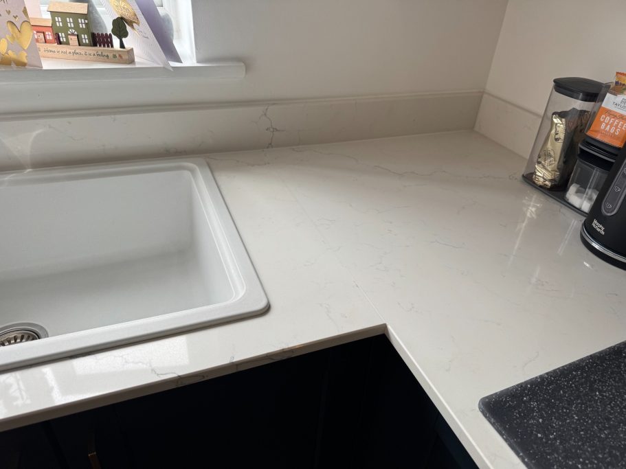 After repair: resealed white quartz joint Picture showing the joint of the worktop reinforced underneath and then resealed on the surface to prevent it from dropping again.