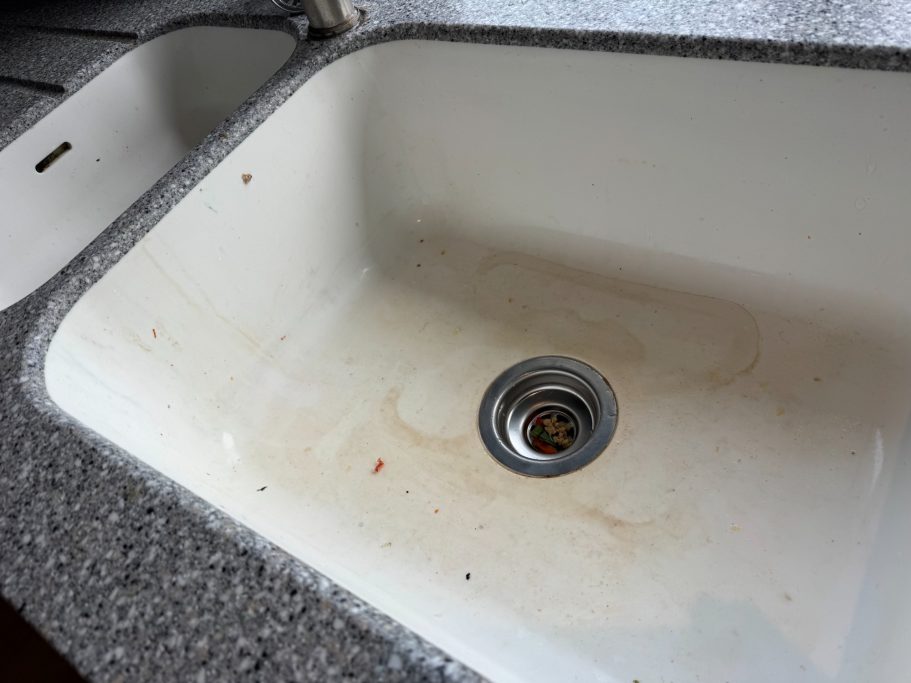 Before restoration: discoloured Corian sink in Weeton White Corian sink damaged with chips and discolouration to the sides and the base of the sink. Also the Corian sink had lost its polish.
