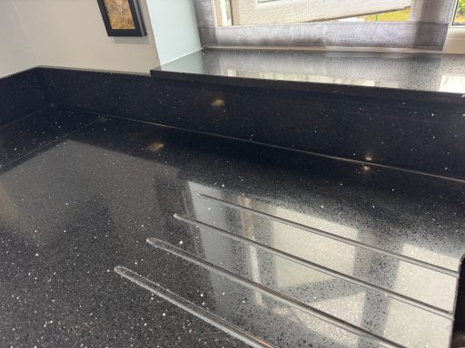 Sink area repolished scratches all removed and chips filled. Black kitchen, Work surface fully polished to a high gloss.