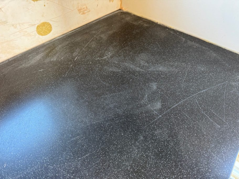 Before restoration: marked black Corian Corian repair cracked worktop, also marked with dints and scuffs all on the surface. Black corian also dull polished finish.